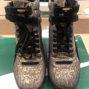 Puma high top sneakers with platform built in.